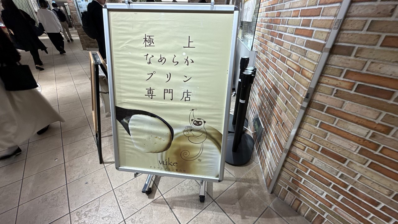 極上なめらかプリン専門店ブーケの文字と看板商品のイラストが描出された店頭看板