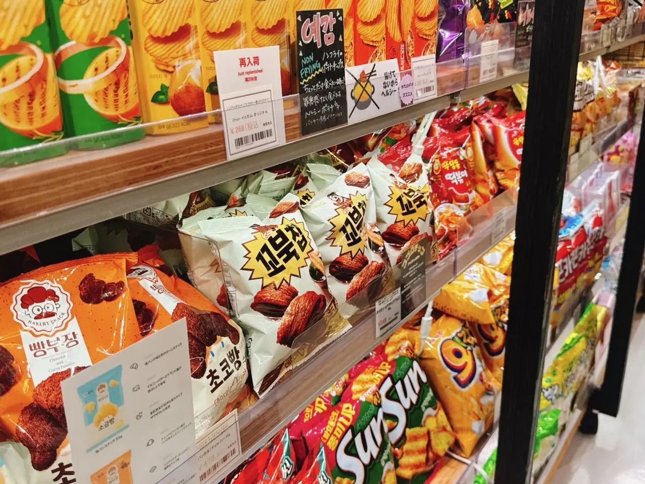 韓国スナック菓子の棚。ノンフライのイェガムやコブクチップ、ひまわりの種が整然と並ぶ様子